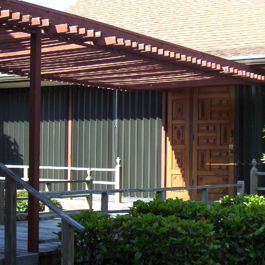 Black accordion hurricane shutters on a beach home