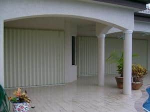 hurricane shutters installed on a white house