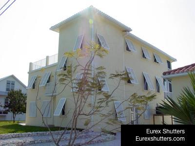 bahama shutters on a yellow home fort myers fl