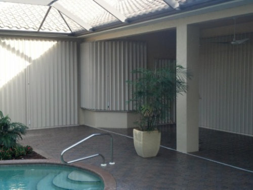 Accordion shutters on house with pool