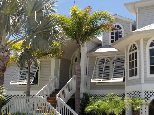 Bahama hurricane shutters over windows of a residential home