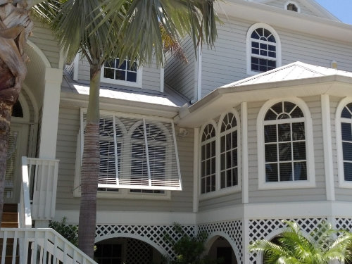Bahama hurricane shutters over windows of a residential home
