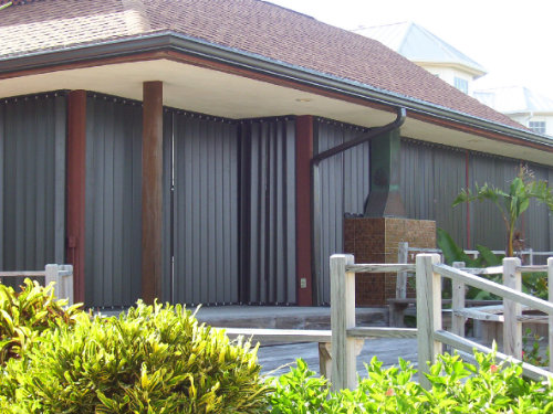 House with bronze accordion shutters