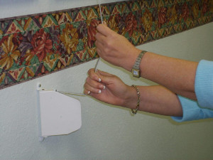 manual roll down hurricane shutter strap system
