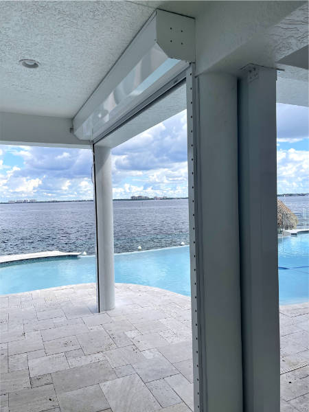 White exterior rolling shutters on a patio in Cape Coral