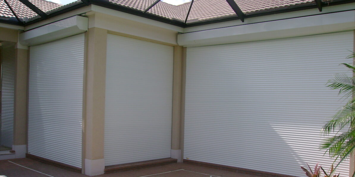manual roll shutters on tan house fl