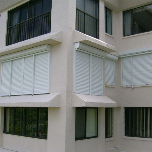 White security shutters shown on a multi-tenant building