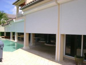 roll down hurricane shutters on patio near pool