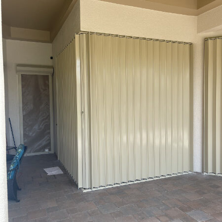 closed accordion hurricane shutters on condo in estero fl