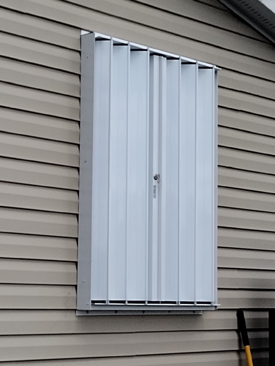 white eurex shutters ptx accordion shutters shown on tan home in lehigh acres fl