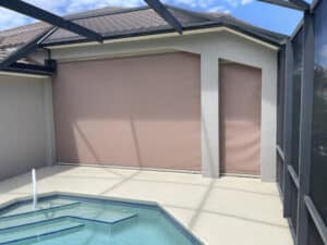Storm screens in closed position on a tan home in Fort Myers