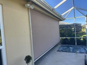 Hurricane screens in partially closed position on a tan home in Fort Myers