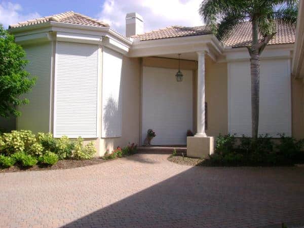 Residential security shutters shown on a home in Florida.