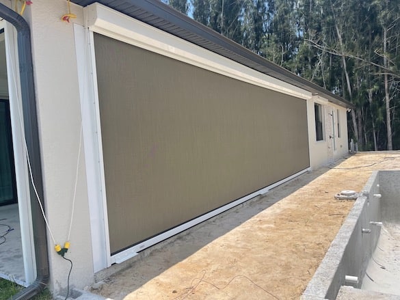 30 foot wide, beige hurricane screen installed on a patio.