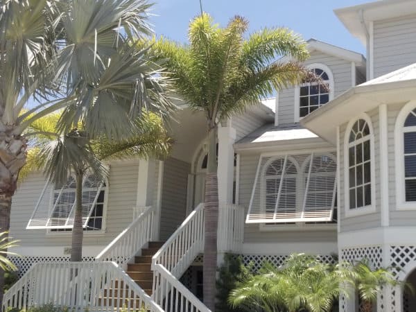 White bahama shutters create the perfect beach feel for this home.