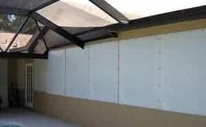white fabric hurricane panels on a beige home