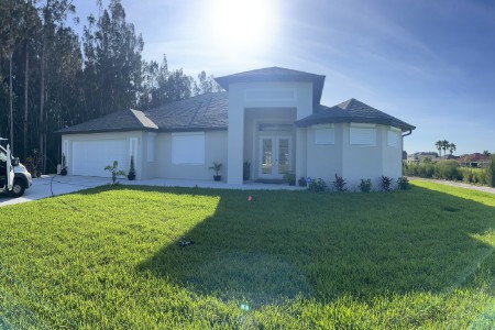 White rolling shutters covering a home's windows in Lehigh Acres Florida