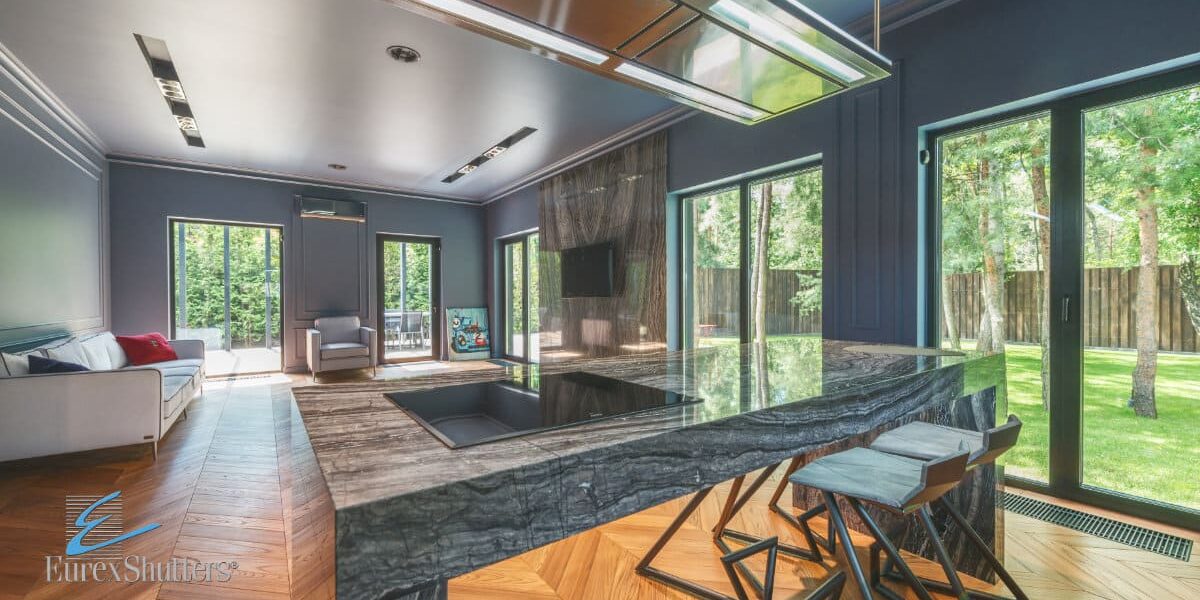 impact-patio-sliding-doors Impact patio sliding doors installed in a kitchen and living room area leading to backyard space.