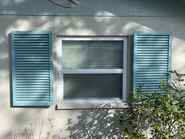 Blue Bahama shutters installed on a home in Venice Florida