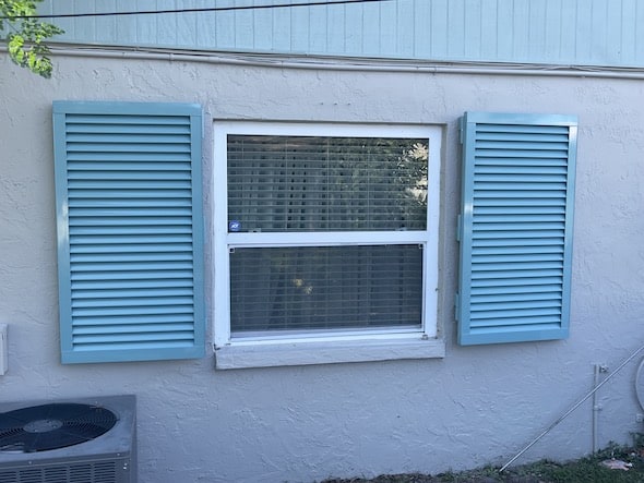 Blue Colonial hurricane shutters installed on a home in Venice Florida