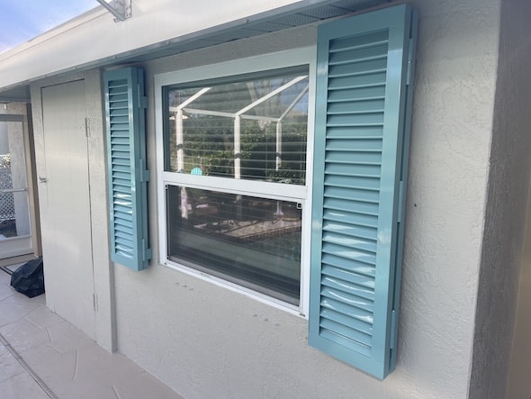 Blue Colonial hurricane shutters installed on a home in Venice Florida