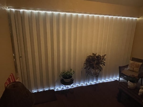 White accordion shutters shown closed at night