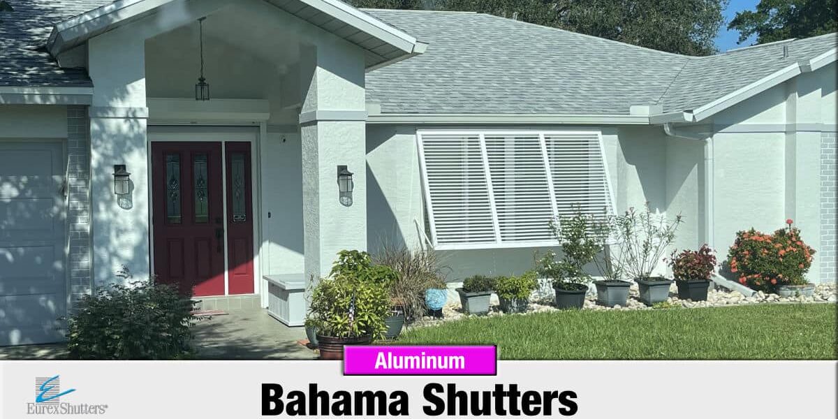 White aluminum bahama shutters on a home