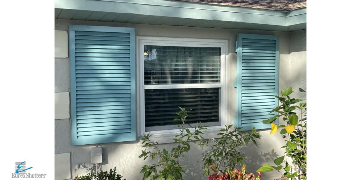colonial-and-bahama-shutters-install-venice-fl Blue Colonial hurricane shutters installed on a home in Venice Florida