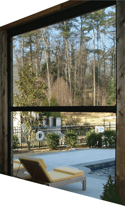 Retractable bug screen installed on a patio looking out to a pool and patio area.