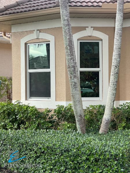 White impact windows without grids shown on a tan home in Florida.