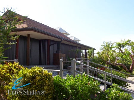 Accordion shutters on a home in the closed position