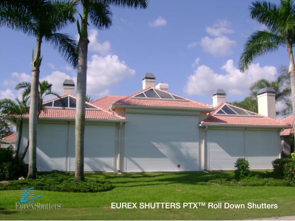 White roll down shutters installed on multiple openings of a home in Southwest Florida.