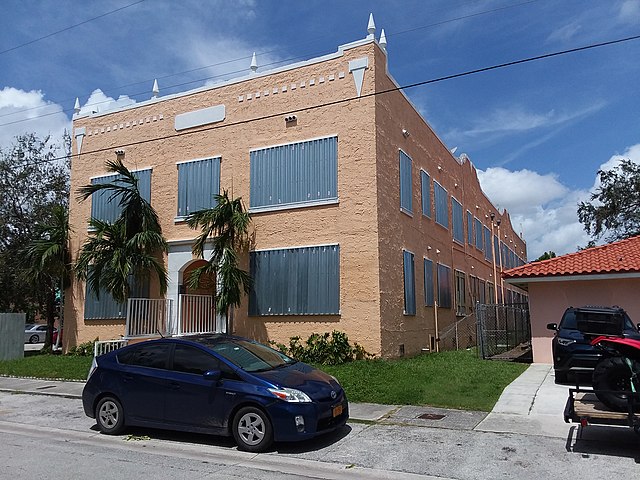 Storm panels installed on a building in Florida. They are one of the more affordable hurricane window protection options, but they are labor intensive.