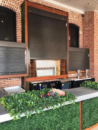 Commercial security shutters shown closed over the bar of a restaurant