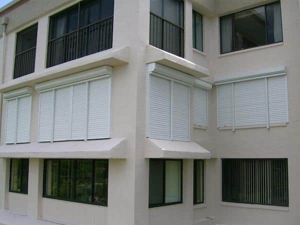 White rolling shutters on commercial building windows.