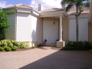 aluminum rolling shutters on a beige home in fort myers fl