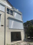 White rolling shutters on a home in Sanibel Florida