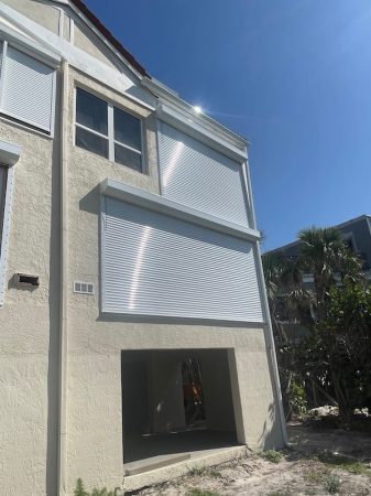 White rolling shutters on a home in Sanibel Florida