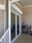 White roll up shutters on a sliding glass door