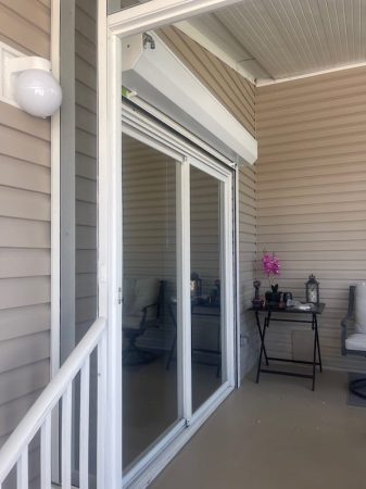 White roll up shutters on a sliding glass door