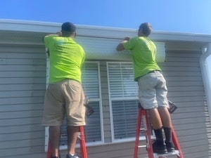Eurex Shutters hurricane shutter installation team installing Eurex Shutters Roll Down Hurricane Shutters on a home in South Fort Myers FL