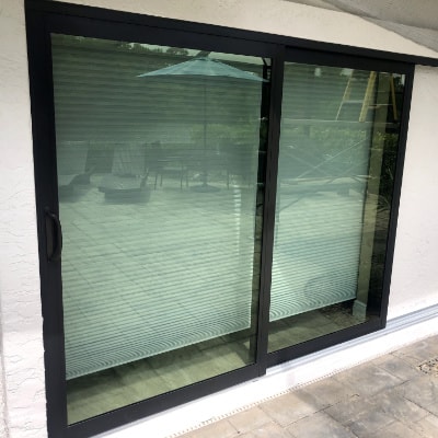 Sliding glass door replacement with bronze, aluminum impact glass sliding door