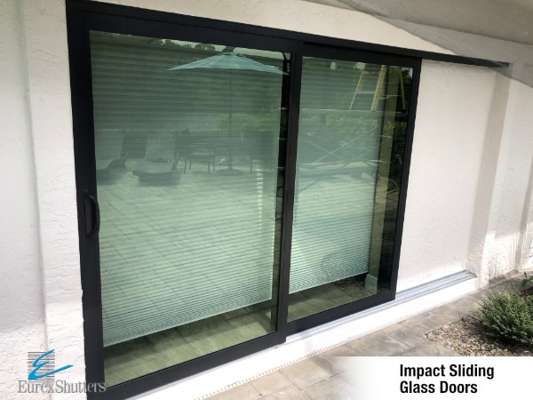 Eurex Shutters impact sliding door installation with aluminum frames.