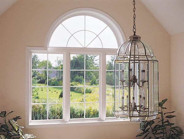 white picture windows with window grids providing a large view outside