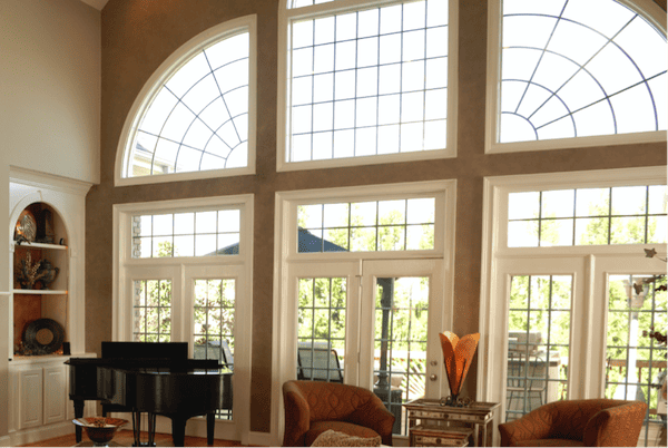 A home with a range of picture windows in different sizes, shapes, and orientations.