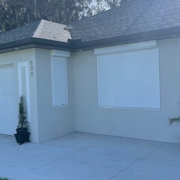 Closed white hvhz roll shutters
