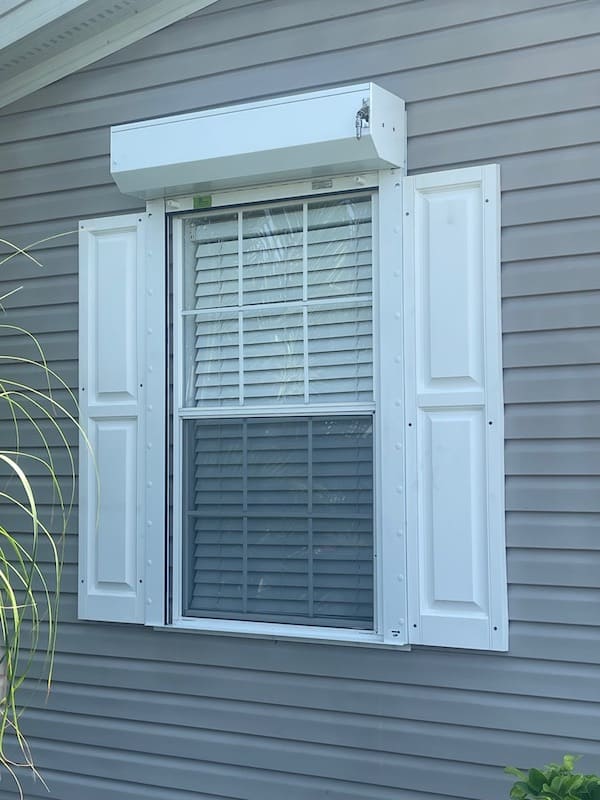 open roll down shutter over a single window