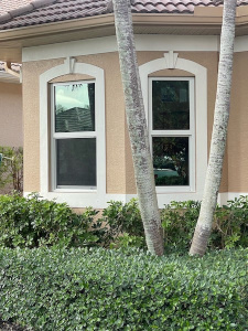 Exterior photo of two impact windows installed by Eurex Shutters in Naples Florida