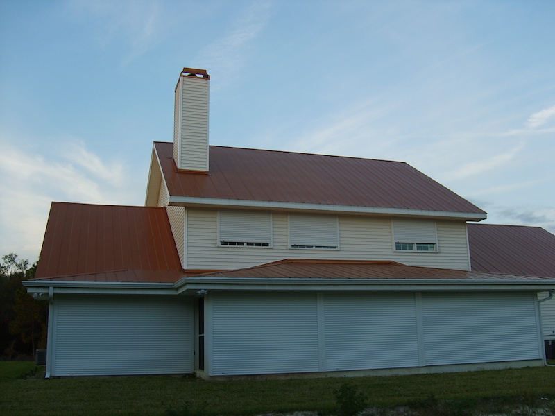 Roll-down hurricane shutter installed on a rural home in Southwest Florida. The housing boxes are installed inside the soffits so they are not visible from the exterior of the home.