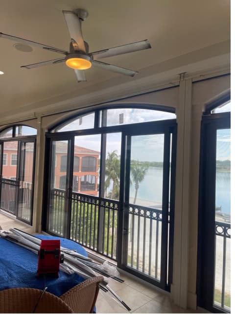 Multiple Bronze, aluminum impact sliders with bronze, aluminum impact windows above the doors